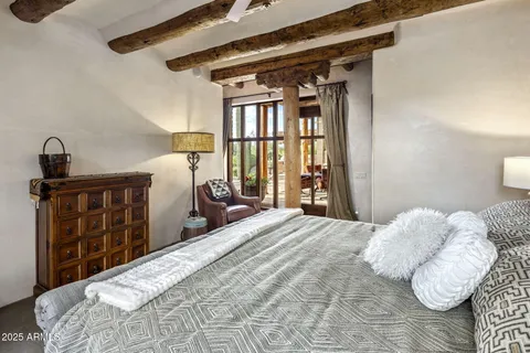 a bedroom with a large bed and a fireplace