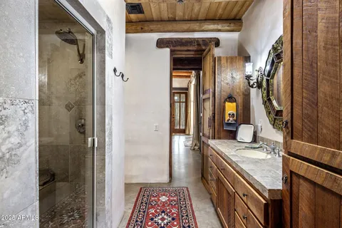 a bathroom with a sink vanity and a mirror