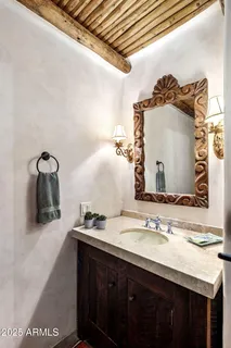 a bathroom with a granite countertop shower a mirror and a sink
