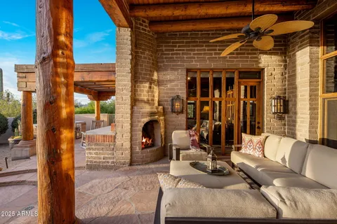 a view of a porch with furniture and floor to ceiling window