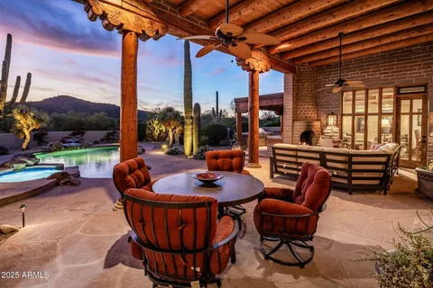 a swimming pool with barbeque oven table and chairs