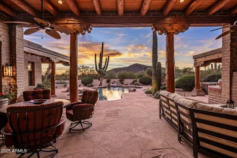 a living room with patio furniture and a floor to ceiling window