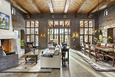 a view of a livingroom with furniture and a large window