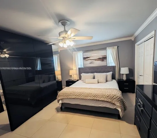 a spacious bedroom with a bed a couch and dresser