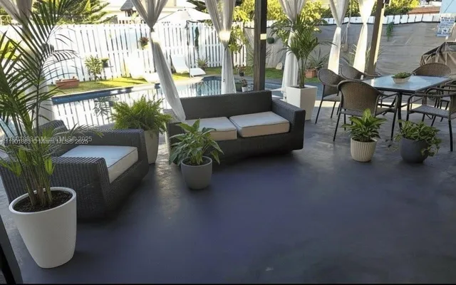 a view of a patio with couches and potted plants