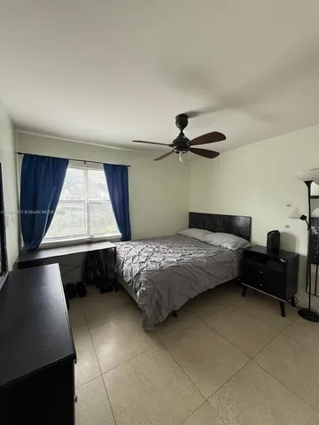 a bedroom with a bed chair and a window