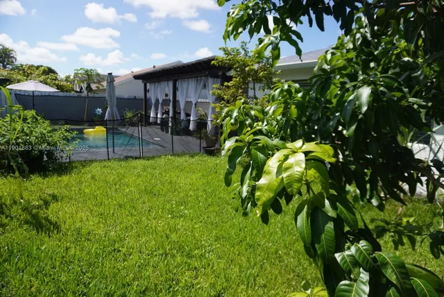 a view of a backyard with sitting area