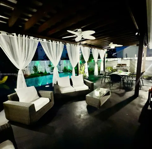 a living room with patio furniture and a fireplace