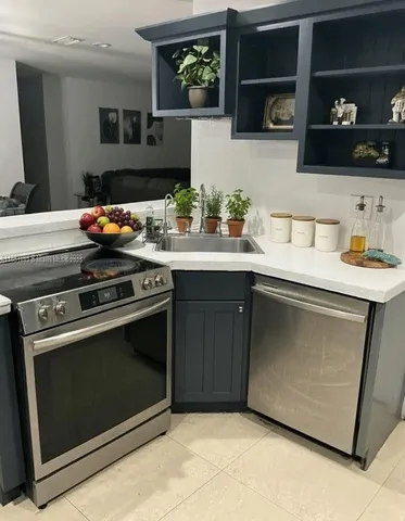 a kitchen with a sink and a stove