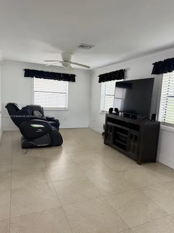 a living room with furniture a projector and a flat screen tv