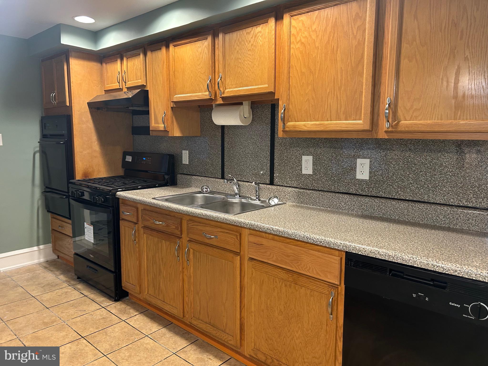 1567 Collings Road Camden, NJ 08104 - Photo 9 of 16 a kitchen with stainless steel appliances granite countertop a sink and a cabinets