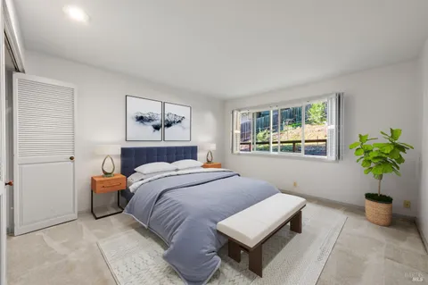 an empty room with windows and fireplace