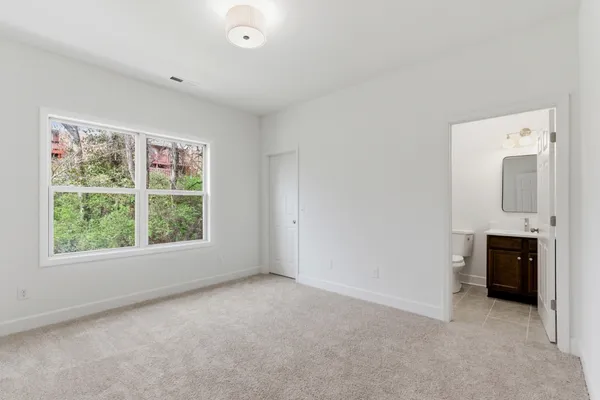 an empty room with fireplace and windows
