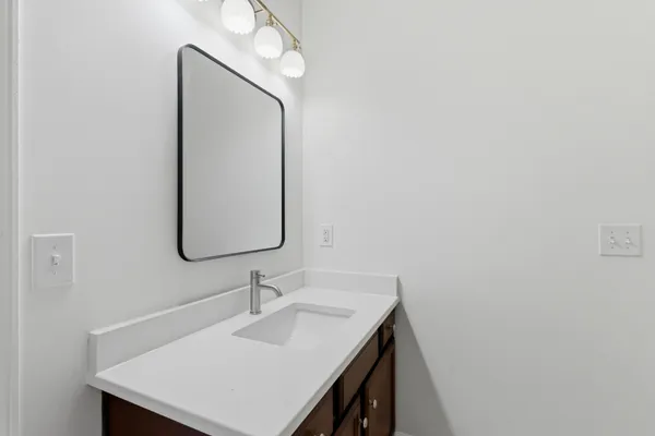 a bathroom with a sink vanity and a mirror