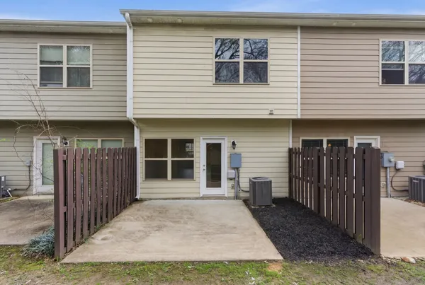 a view of a house with wooden fence