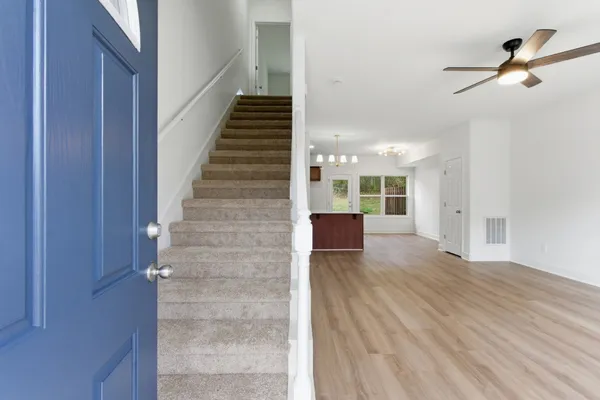 a view of an entryway with wooden floor and door