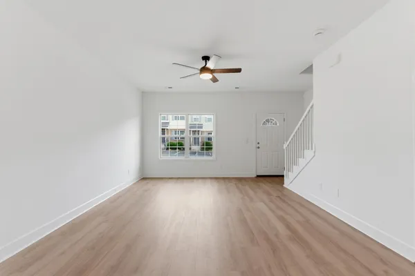 wooden floor in an empty room with a window