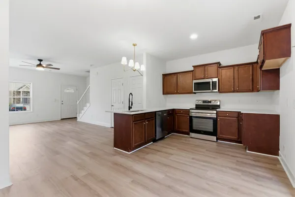 a kitchen with a stove a sink and a microwave
