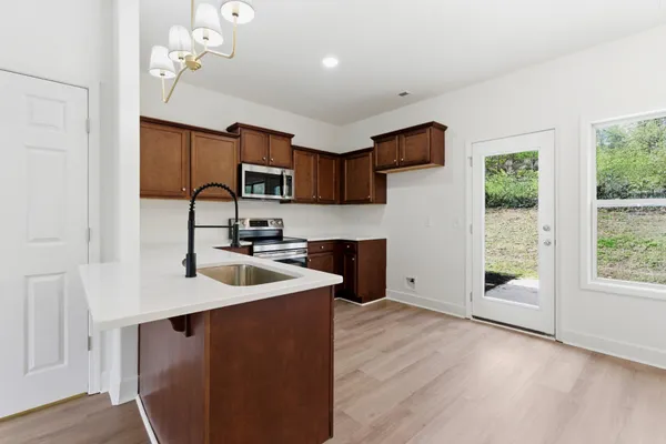a kitchen with sink cabinets and window