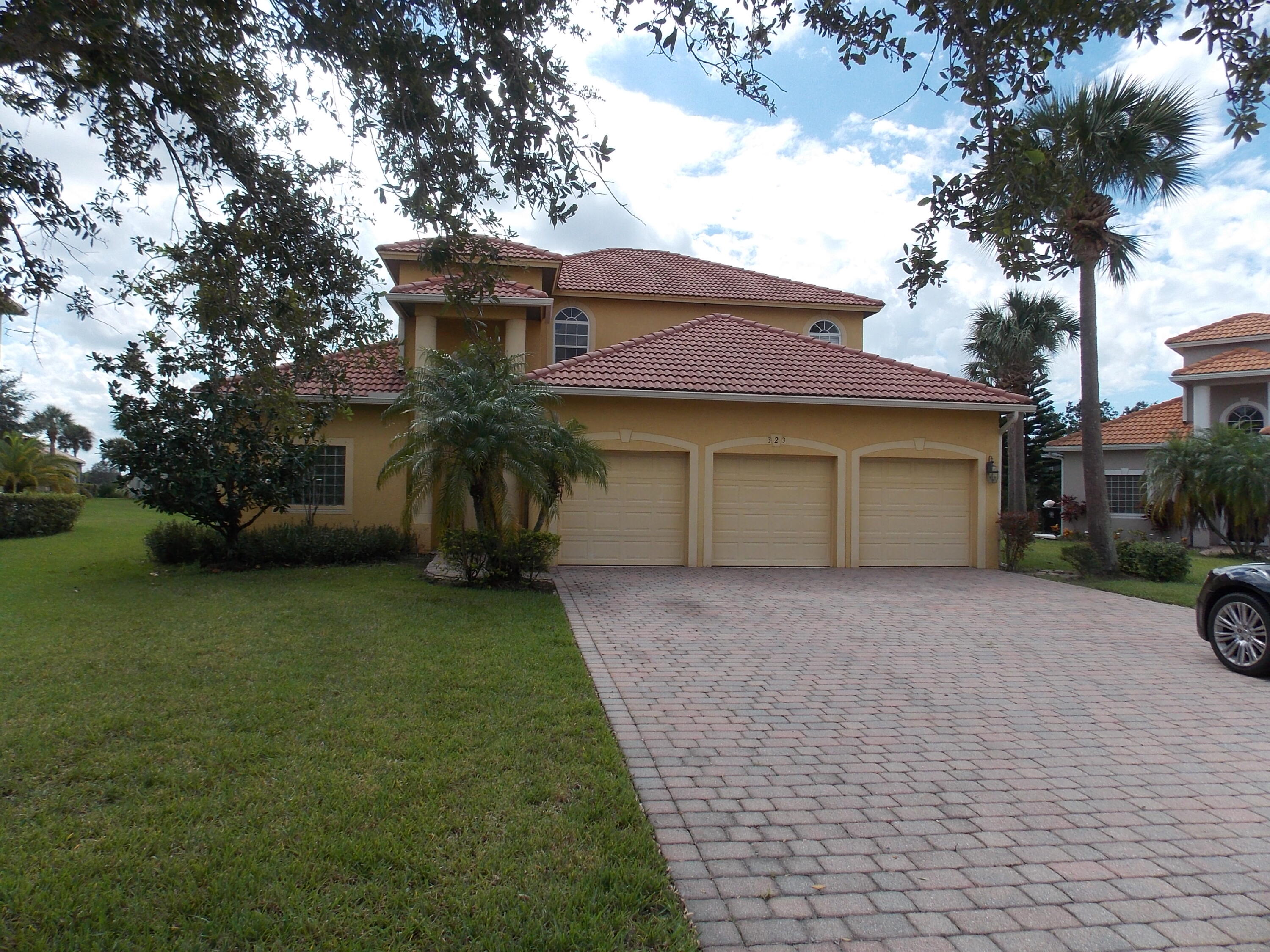 323 Northwest Sheffield Circle Port St. Lucie, FL 34983 - Photo 1 of 31 a front view of a house with garden