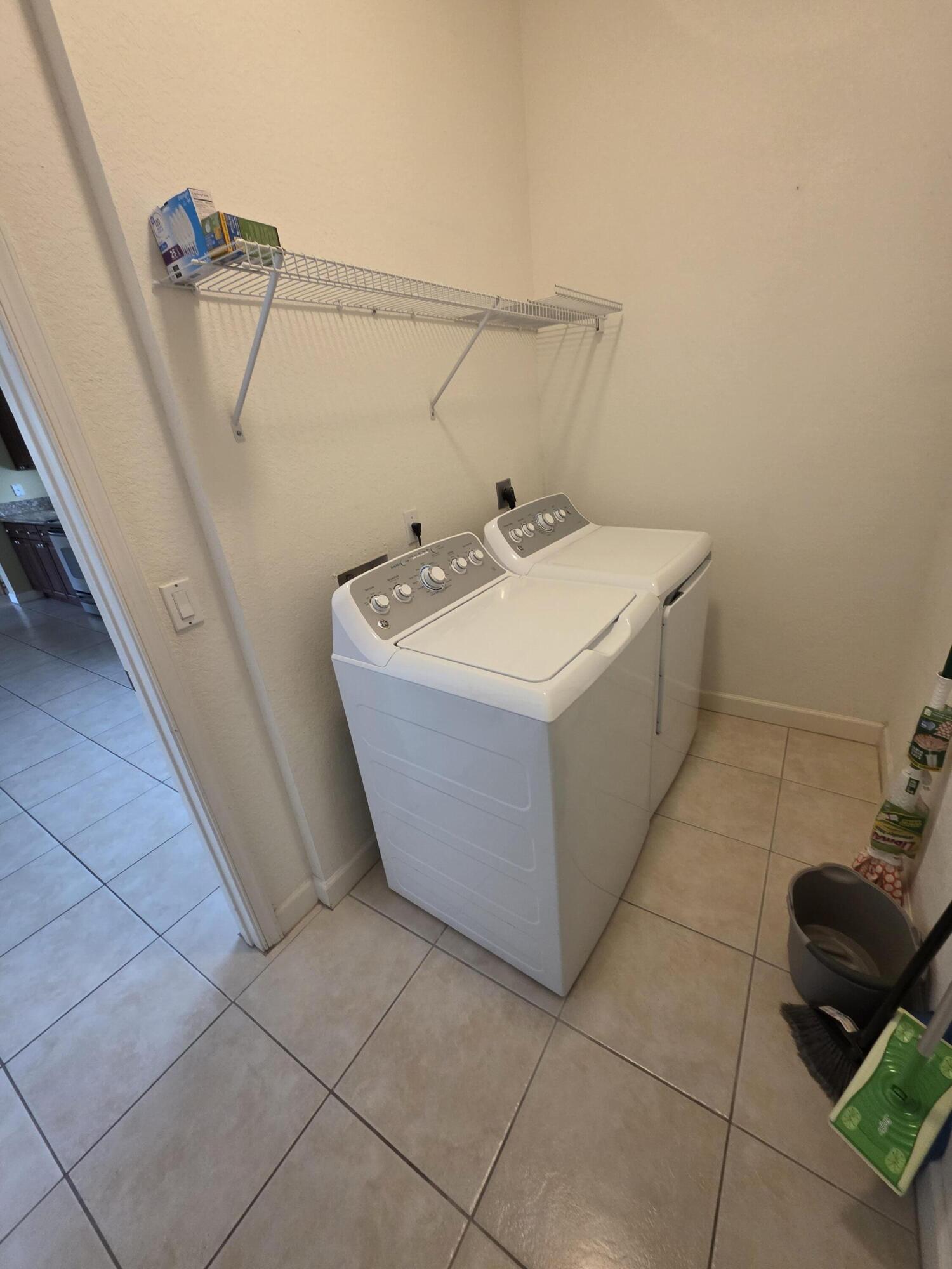 323 Northwest Sheffield Circle Port St. Lucie, FL 34983 - Photo 12 of 31 a utility room with a sink a toilet and a mirror