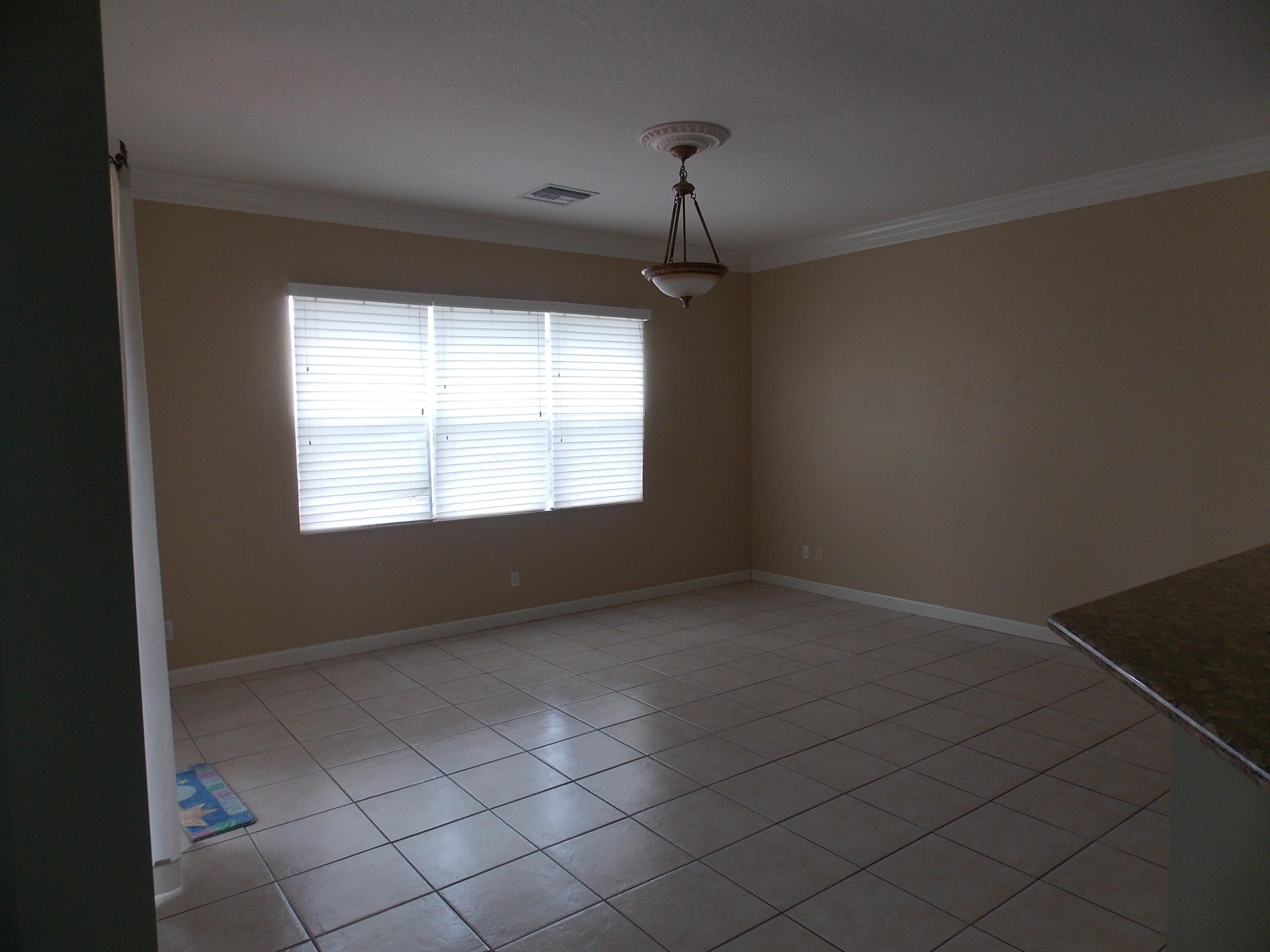 323 Northwest Sheffield Circle Port St. Lucie, FL 34983 - Photo 7 of 31 an empty room with windows