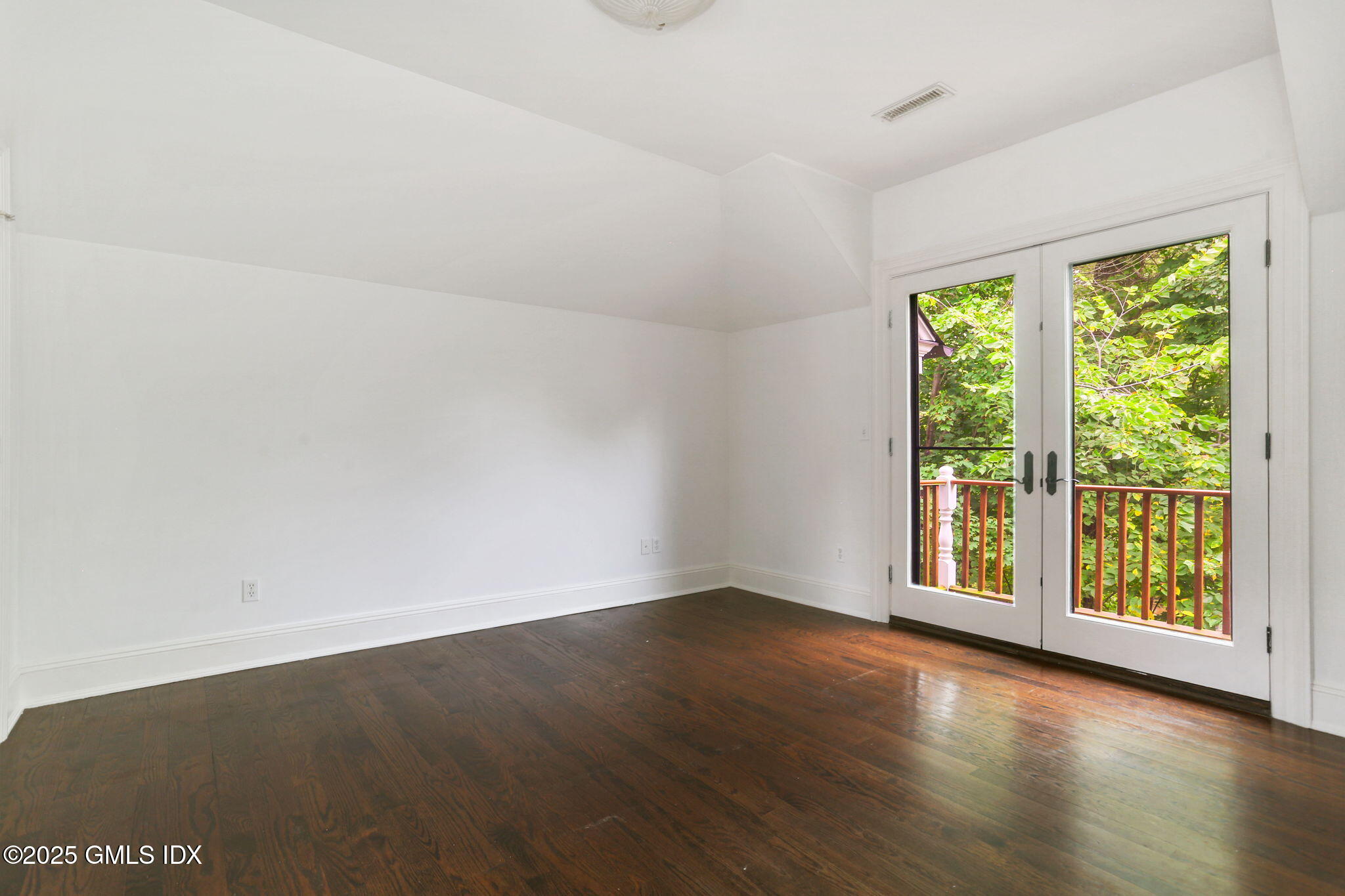 11 Harding Road Old Greenwich, CT 06870 - Photo 25 of 31 an empty room with wooden floor and windows