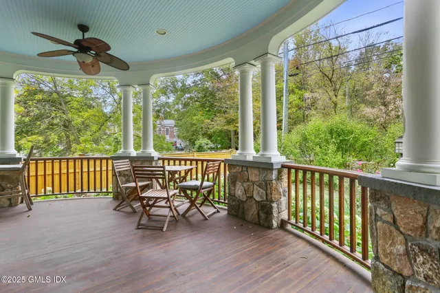 a view of a porch with furniture and wooden floor