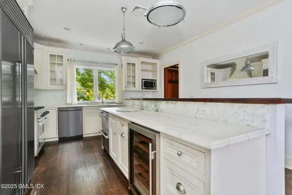 a kitchen with a stove a sink and a refrigerator