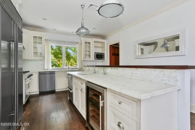 a kitchen with a stove a sink and a refrigerator