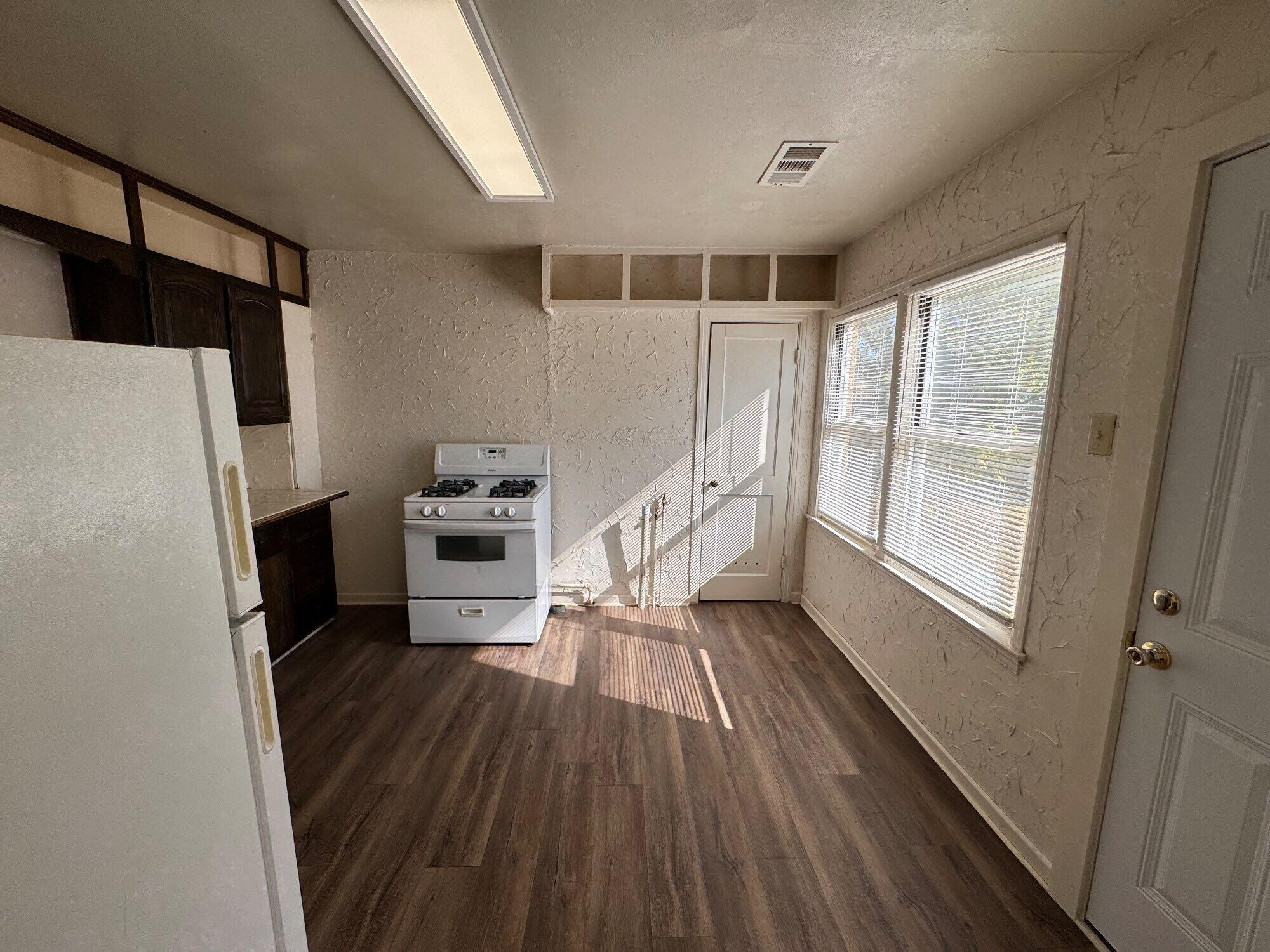 2119 32nd Street Lubbock, TX 79411 - Photo 4 of 9 a view of wooden floor in a kitchen