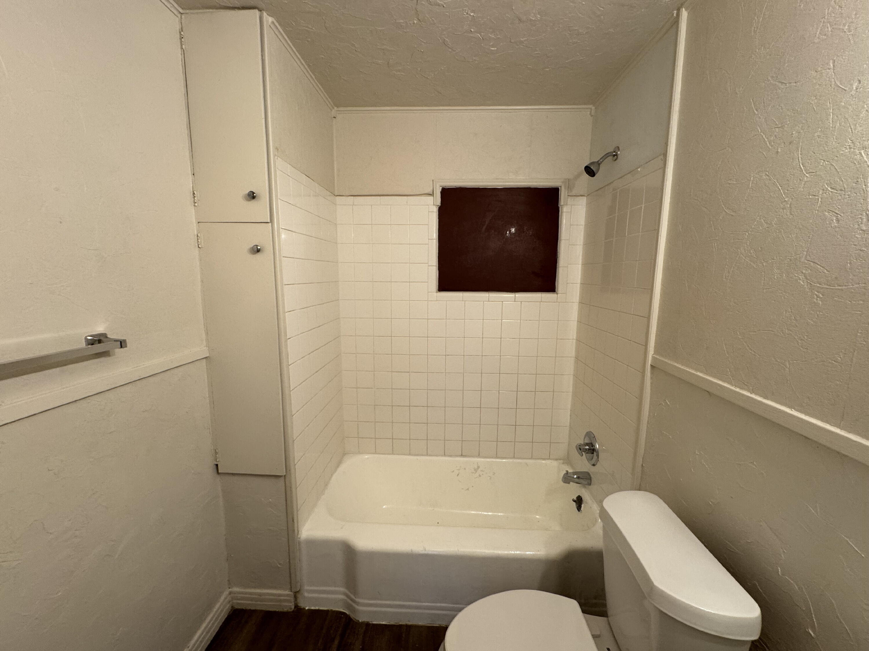 2119 32nd Street Lubbock, TX 79411 - Photo 8 of 9 a bathroom with a toilet and a bathtub