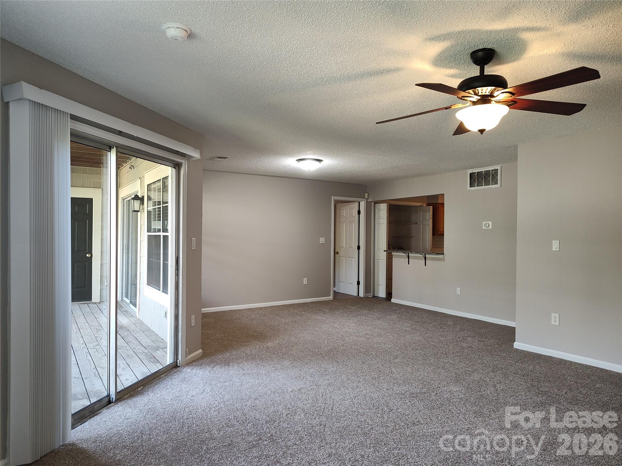 5001 Sharon Road, Unit K Charlotte, NC 28210 - Photo 12 of 24 a view of empty room with a ceiling fan