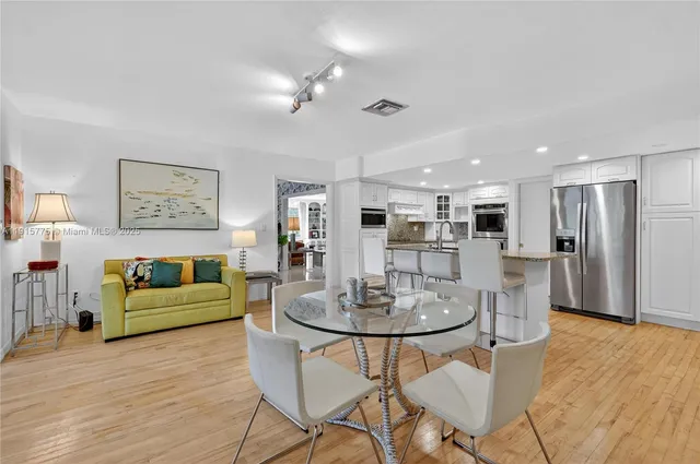 a living room with furniture and kitchen view