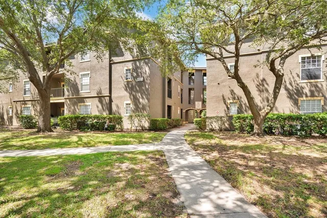 a view of a large trees in front of a house