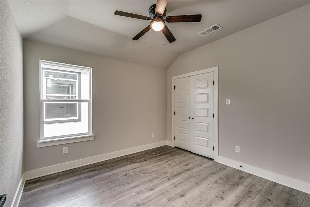 912 Cooksey Court, Unit B Grandview, TX 76050 - Photo 18 of 30 a view of empty room with wooden floor and fan