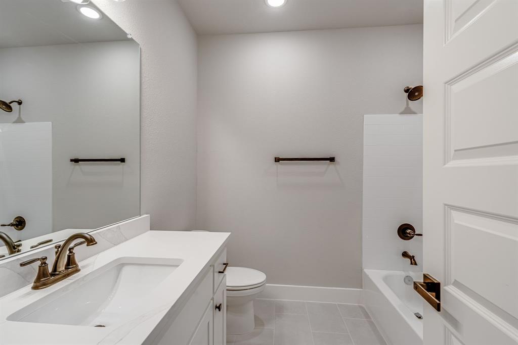 912 Cooksey Court, Unit B Grandview, TX 76050 - Photo 19 of 30 a bathroom with a sink a toilet and shower