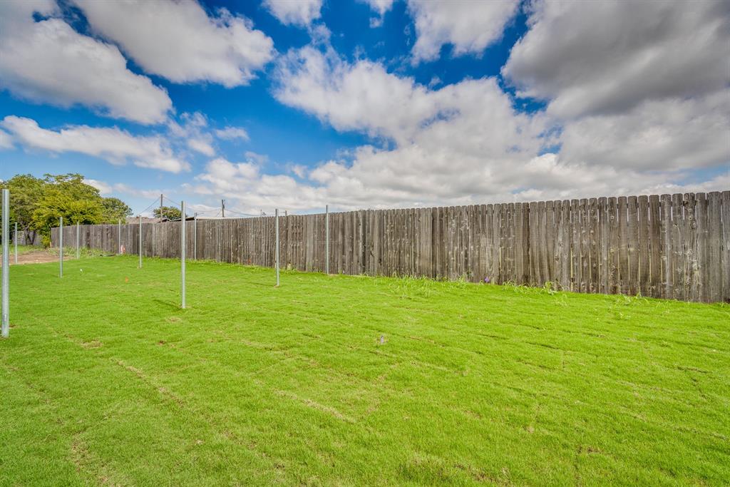 912 Cooksey Court, Unit B Grandview, TX 76050 - Photo 30 of 30 a view of a backyard with grass and entertaining space