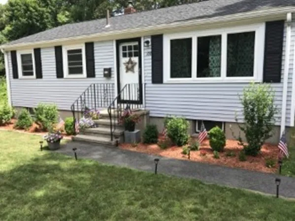 a backyard of a house with outdoor seating