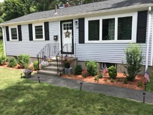 a backyard of a house with outdoor seating