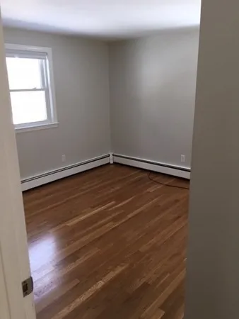 a view of room with window and hardwood floor