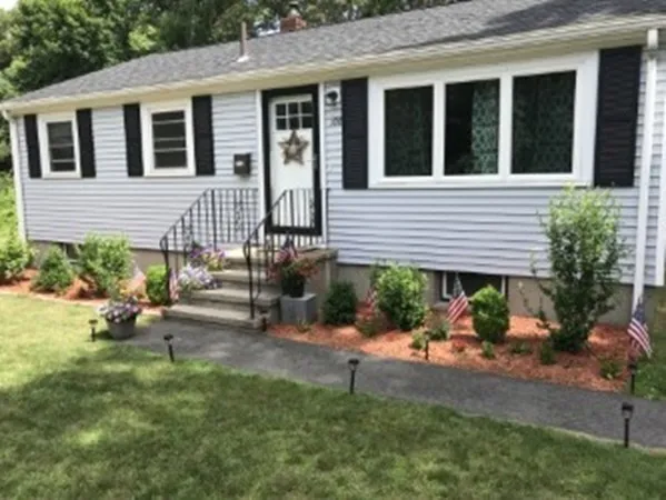 a backyard of a house with outdoor seating
