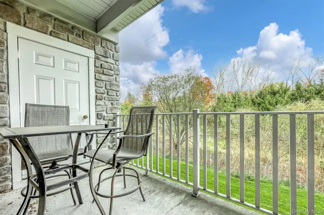 a view of a chair and table in the balcony