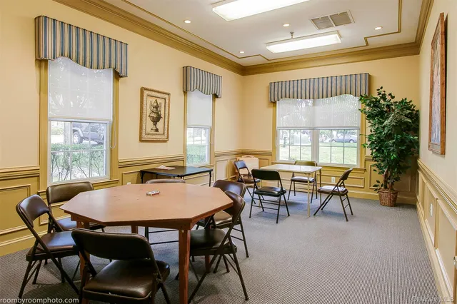 a view of a dining room with furniture and a window