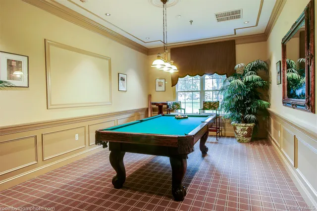 a room with pool table and windows
