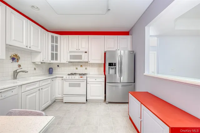 a kitchen with a refrigerator sink and cabinets