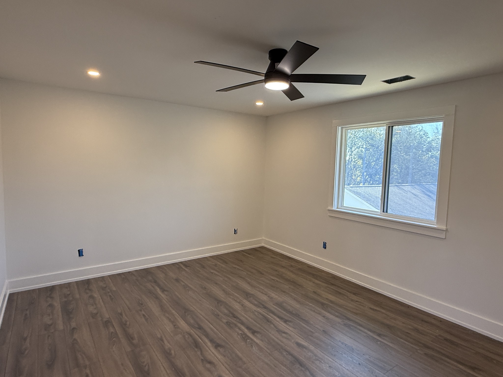 3880 Barfield Crescent Road Murfreesboro, TN 37128 - Photo 16 of 26 an empty room with wooden floor ceiling fan and windows