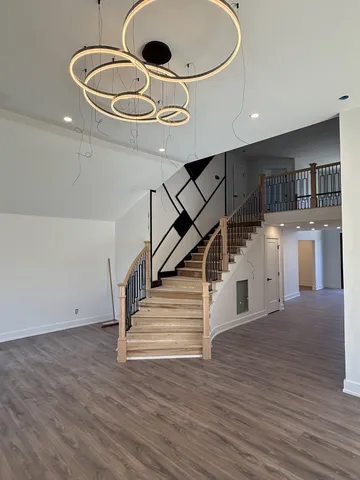 a view of entryway and kitchen with wooden floor