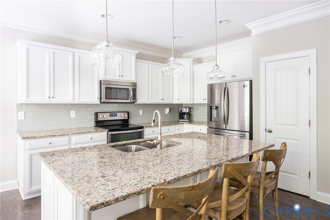 15206 Blackrail Road Chesterfield, VA 23832 - Photo 14 of 50 a kitchen with stainless steel appliances granite countertop a kitchen island hardwood floor sink stove and microwave
