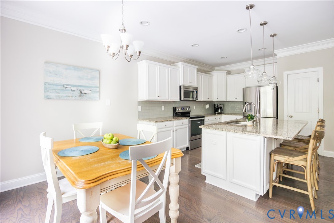 15206 Blackrail Road Chesterfield, VA 23832 - Photo 16 of 50 a kitchen with kitchen island granite countertop white cabinets and stainless steel appliances